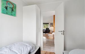 Kolby KåsGorgeous Home In Sams With Kitchen的一间卧室配有一张床,一扇门通往客厅