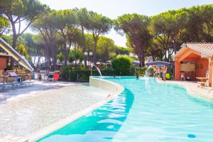 阿尔比尼娅Gitavillage Il Gabbiano的度假村的游泳池,人们在里面玩耍