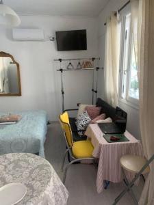 萨罗尼扎Παραθαλάσσιο στούντιο με κήπο的小房间设有桌子和床