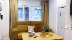 毕尔巴鄂Deustown Apartamentos的客厅配有沙发和桌子