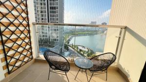 河内NanaHousing-Vinhomes Skylake-Luxury Apartment near Keangnam的阳台配有两把椅子,享有河景