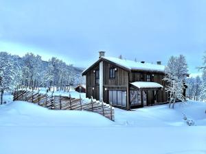 耶卢Budalstølen-ny og flott hytte-sentral beliggenhet的雪中小屋,有雪覆盖的树木