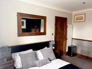 莱斯特Santalijshoteliers Rm5的卧室配有一张床,墙上设有镜子