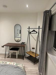 KensaleyreChieftain’s Cabin的一间卧室配有桌子、镜子和书桌
