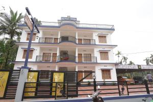 MānantoddyCasa Maria Mystica apartments, Mananthavady, Wayanad的前面有栅栏的白色房子