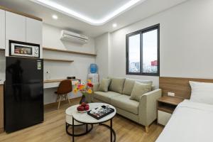 河内22housing Residence Suites的客房设有床、沙发和桌子。