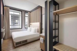 鹿特丹Motto By Hilton Rotterdam Blaak的卧室配有白色的床和窗户。