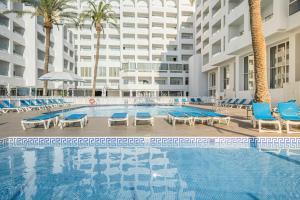 莫哈卡尔最佳英达罗酒店的一座带蓝色椅子的大型游泳池和一座建筑