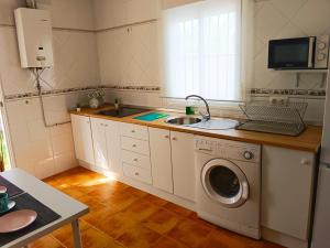 奇克拉纳－德拉弗龙特拉Chalet Mari Carmen的厨房配有水槽和洗衣机