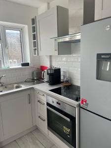 Forest HillJust Plan B Homes的厨房配有白色橱柜和炉灶烤箱。