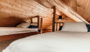 惠斯勒河畔度假酒店的小木屋内一间卧室,配有两张床