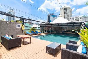 曼谷康帕斯酒店集团曼谷素坤逸10巷格乐丽雅酒店的建筑物屋顶上的游泳池