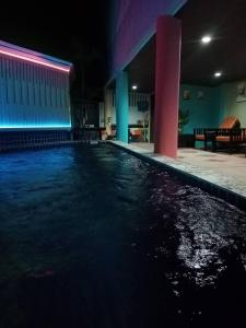 拉迈Colorize Boutique Hotel的夜间在房子里的一个游泳池