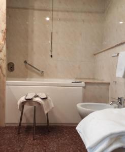 伊塞尔尼亚欧洲大酒店的带浴缸、卫生间和盥洗盆的浴室