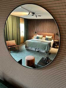 哥德堡斯巴尔加尔达酒店的一间卧室配有一张大床和镜子