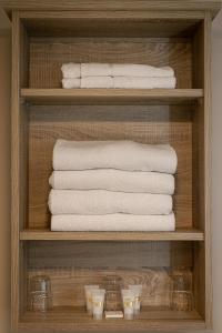 特拉利特瑞联排别墅的浴室内带毛巾和其他毛巾的架子