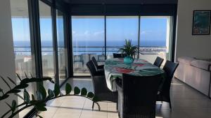 帕皮提Kaili Ocean view luxury 2BR AC throughout Fiber Wifi & Pool的海景客房内的桌椅