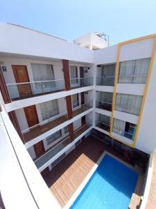 帕拉卡斯Hotel Golf Paracas的从带游泳池的大楼的阳台上可欣赏到风景