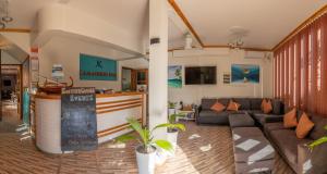 芭环礁Kamadhoo Inn的带沙发和酒吧的客厅