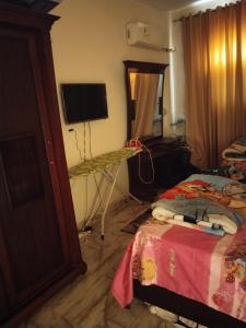 开罗Elfahd的一间卧室配有一张床、一台电视和一张桌子