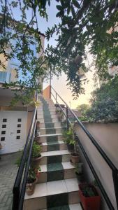 地拉那Karanxha's room的房屋一侧有盆栽植物的楼梯