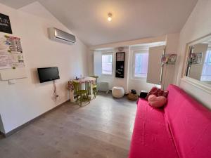 帕苏迪阿尔库什Apartamento com escada e pátio, em frente praia的客厅配有粉红色的沙发和桌子
