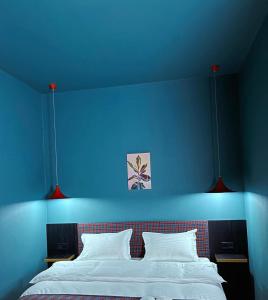 库塔伊西Green Rooms的蓝色的卧室,配有一张蓝色墙壁的床