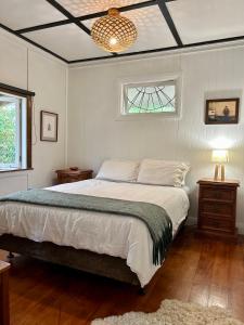 汉密尔顿Charming Country Retreat的一间卧室设有一张大床和一个窗户。