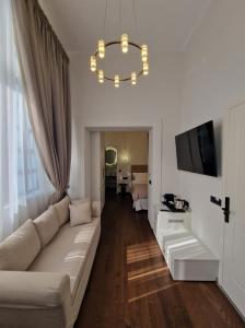 罗德镇Jensen Luxury Suites的带沙发和电视的白色客厅
