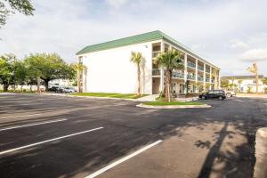 弗利Econo Lodge Inn & Suites Foley-North Gulf Shores的大型建筑前的停车场