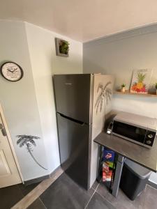 圣安尼Kaz ananas, spa privatif ,plage du Helleux的厨房配有冰箱和微波炉。