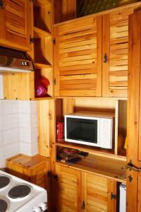 利维松多里Il Rifugio da Aldo - Rivisondoli的厨房配有木制橱柜和台面上的微波炉