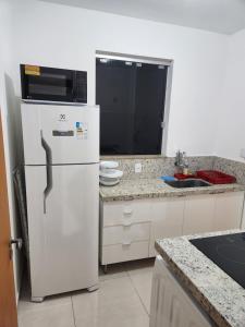 塞蒂拉瓜斯Comfort 302 - 4 Quartos no Centro的厨房配有白色冰箱和微波炉