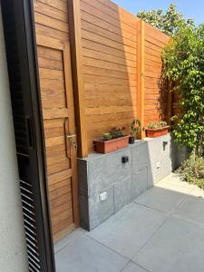 开罗Oriana Villa Guest House的木门,栅栏上放着盆栽植物