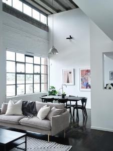 墨尔本Chic Urban Loft in Prime Location的客厅配有沙发和桌子