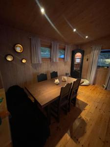 哈默菲斯特Nordmannsneset på Seiland的一间带木桌和椅子的用餐室