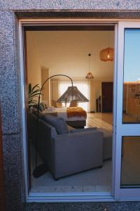 埃斯平霍44 Forty Four Coast - Espinho的客厅配有沙发和桌子,透过窗户