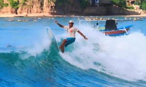 Bumbang龙目岛冲浪花园酒店的海浪冲浪的人