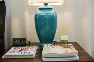 米兰柏林酒店的蓝色的花瓶坐在桌子上,上面有书