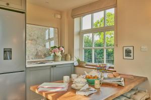 AshingtonThe Pump House的厨房配有木桌和窗户。