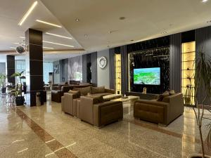 埃尔比勒MyHotel Erbil的带沙发和平板电视的大堂。