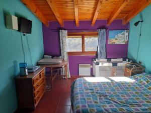 蒙特费雷Apartament Gran Pirineu的一间卧室设有紫色和蓝色的墙壁和一张床