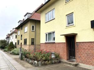 欧登塞One Bedroom Apartment In Odense, Middelfartvej 259的街上一排鲜花的房子