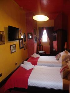 威根斯文里法夫特斯宾馆的一间酒店客房,设有三张床和一台平面电视