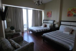 迈阿密海滩2 BD Penthouse with Balcony的酒店客房带两张床、一张沙发和一个客厅。