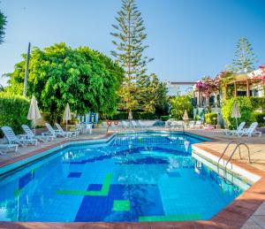 古瓦伊Your Memories Hotel的一座带椅子和树的大型游泳池