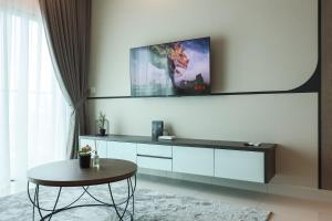 八打灵再也Greenfield Residence, Bandar Sunway by The Comfort Zone的客厅配有桌子和墙上的电视