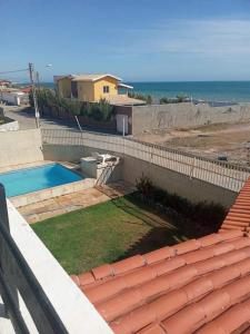 考卡亚Pousada e Hostel Lua de Tomate的一个带游泳池和大海的后院