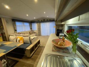 塞顿港Seton Sands Haven Holiday Park - Prestige Caravan的客厅配有沙发和桌子