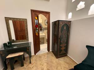 丹吉尔Riad Al-Qurtubi的一间设有钢琴、镜子和门的房间